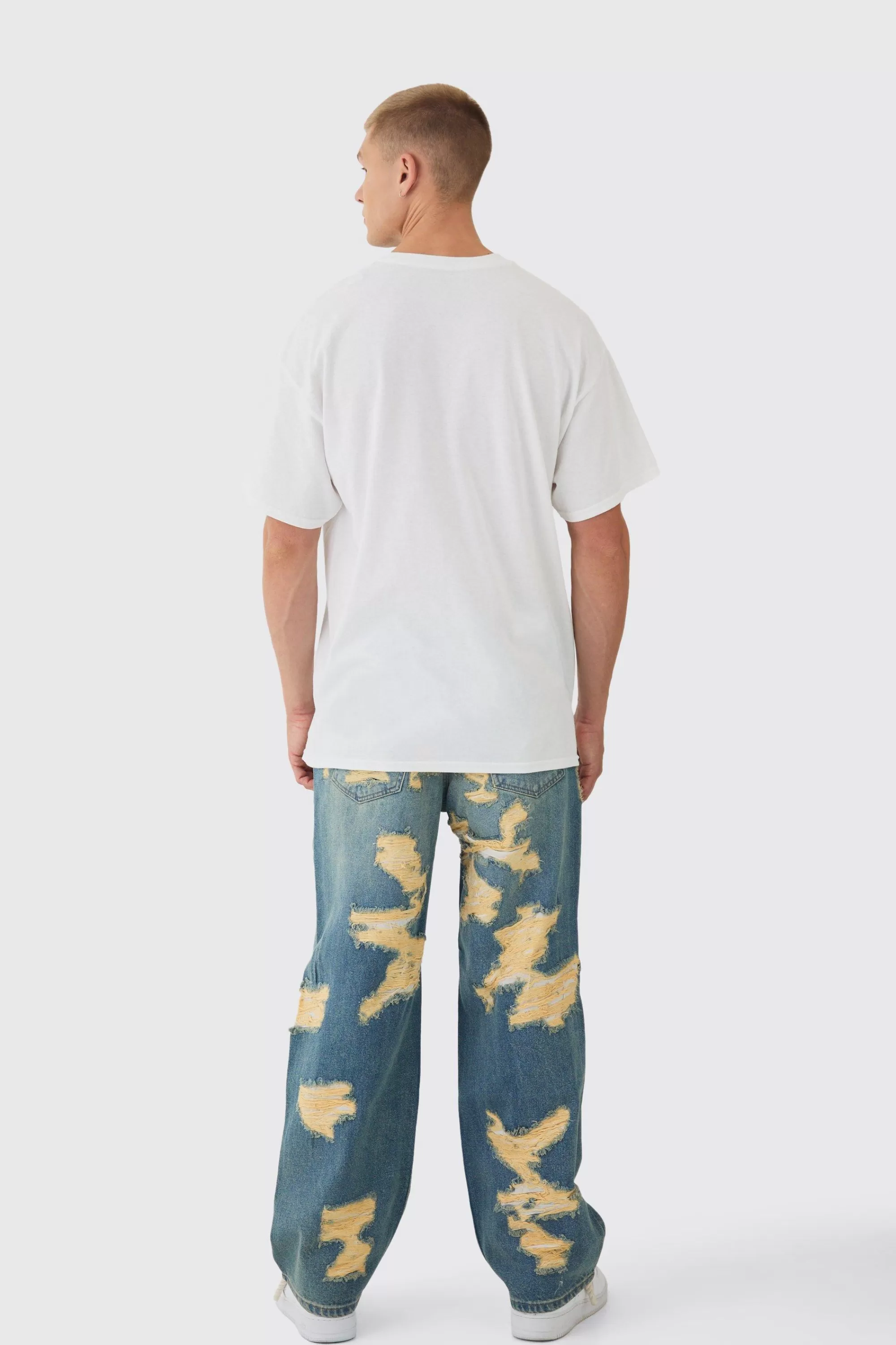 boohooMAN Baggy Fit Rigid All Over Ripped Jeans | UK