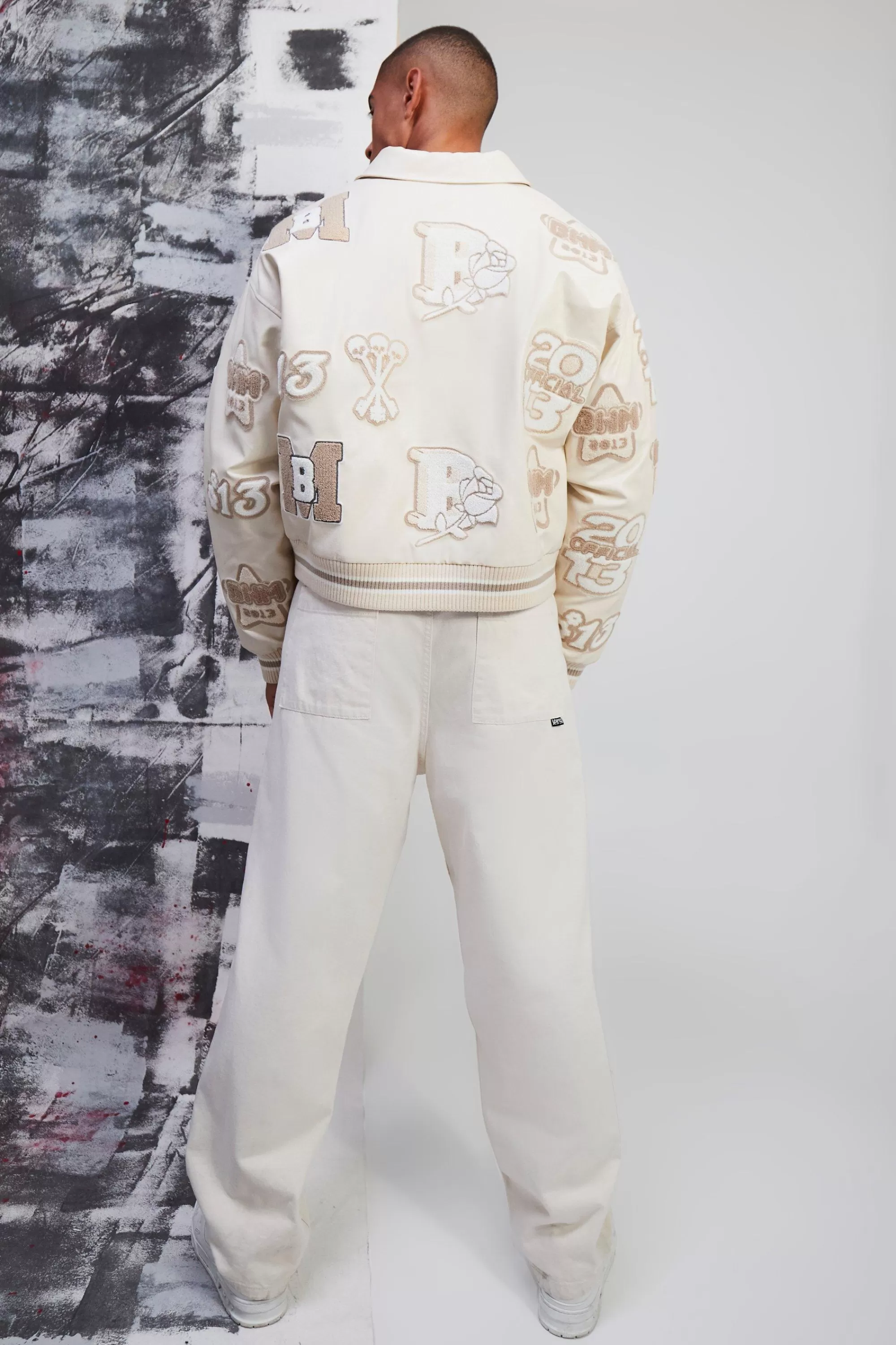 boohooMAN Boxy Pu Tonal Badge Varsity Jacket | UK