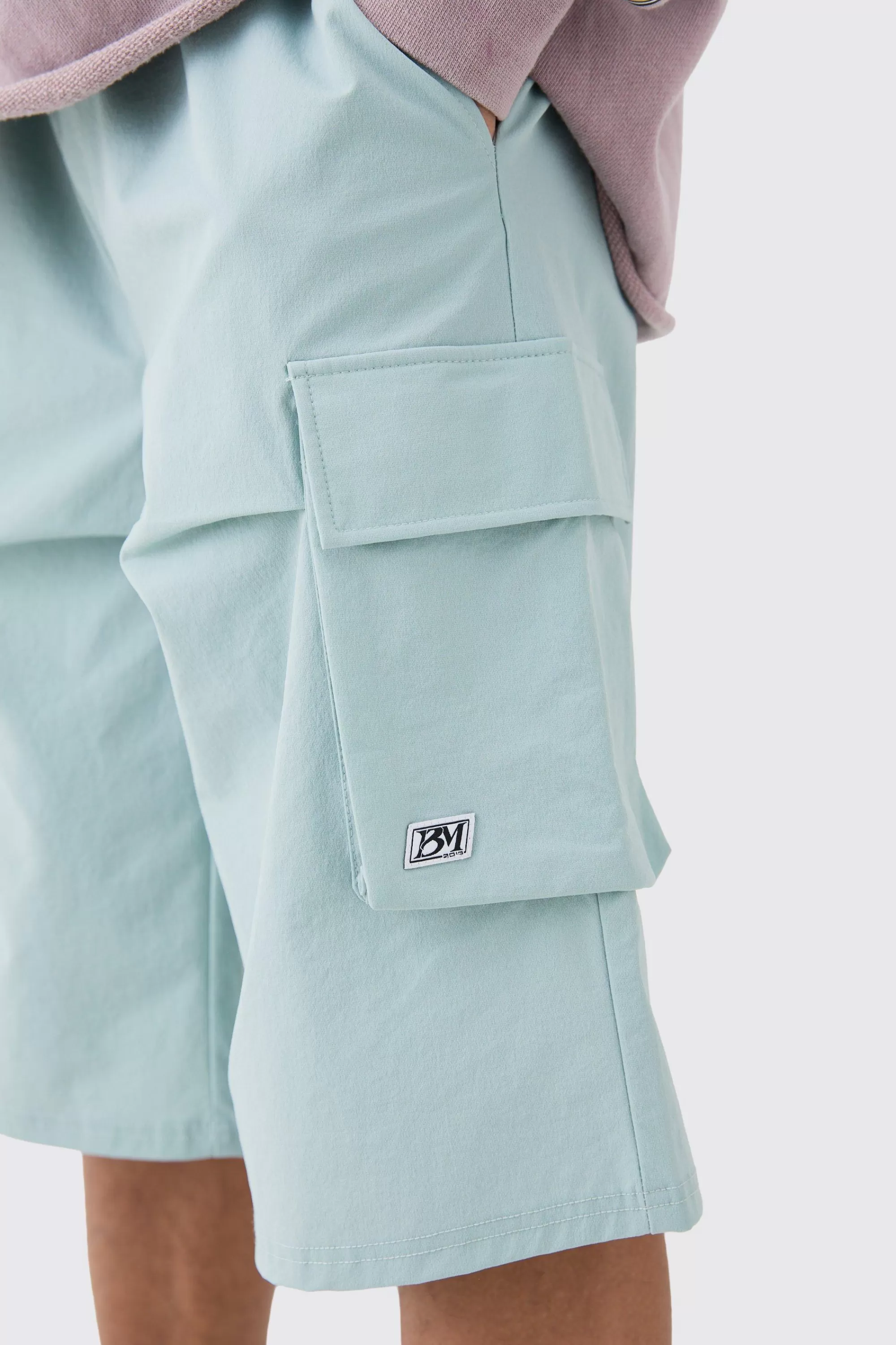 boohooMAN Elasticated Relaxed Technical Stretch Short With Branding | UK