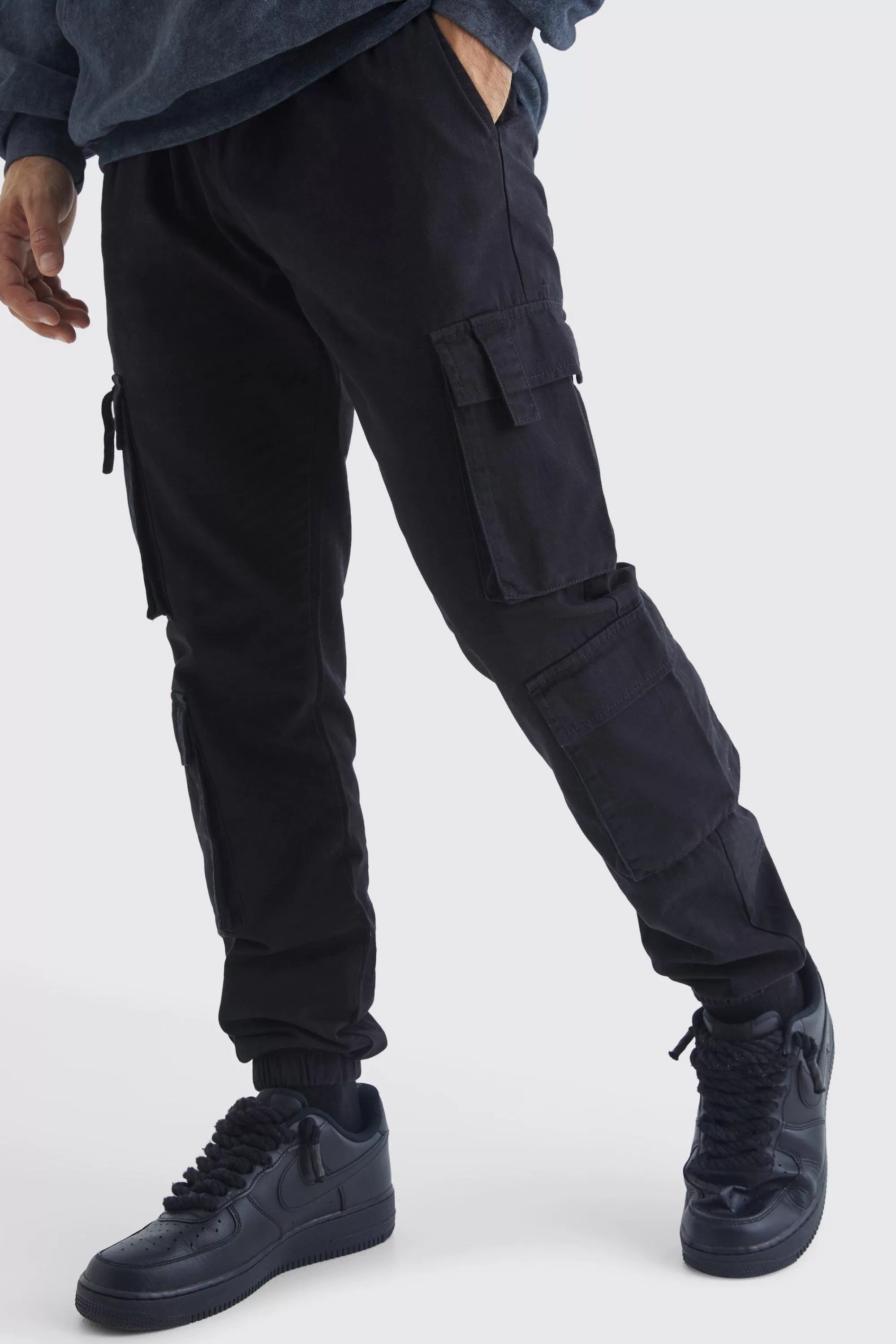 boohooMAN Elasticated Waist Multi Cargo Pocket Slim Fit Jogger | UK