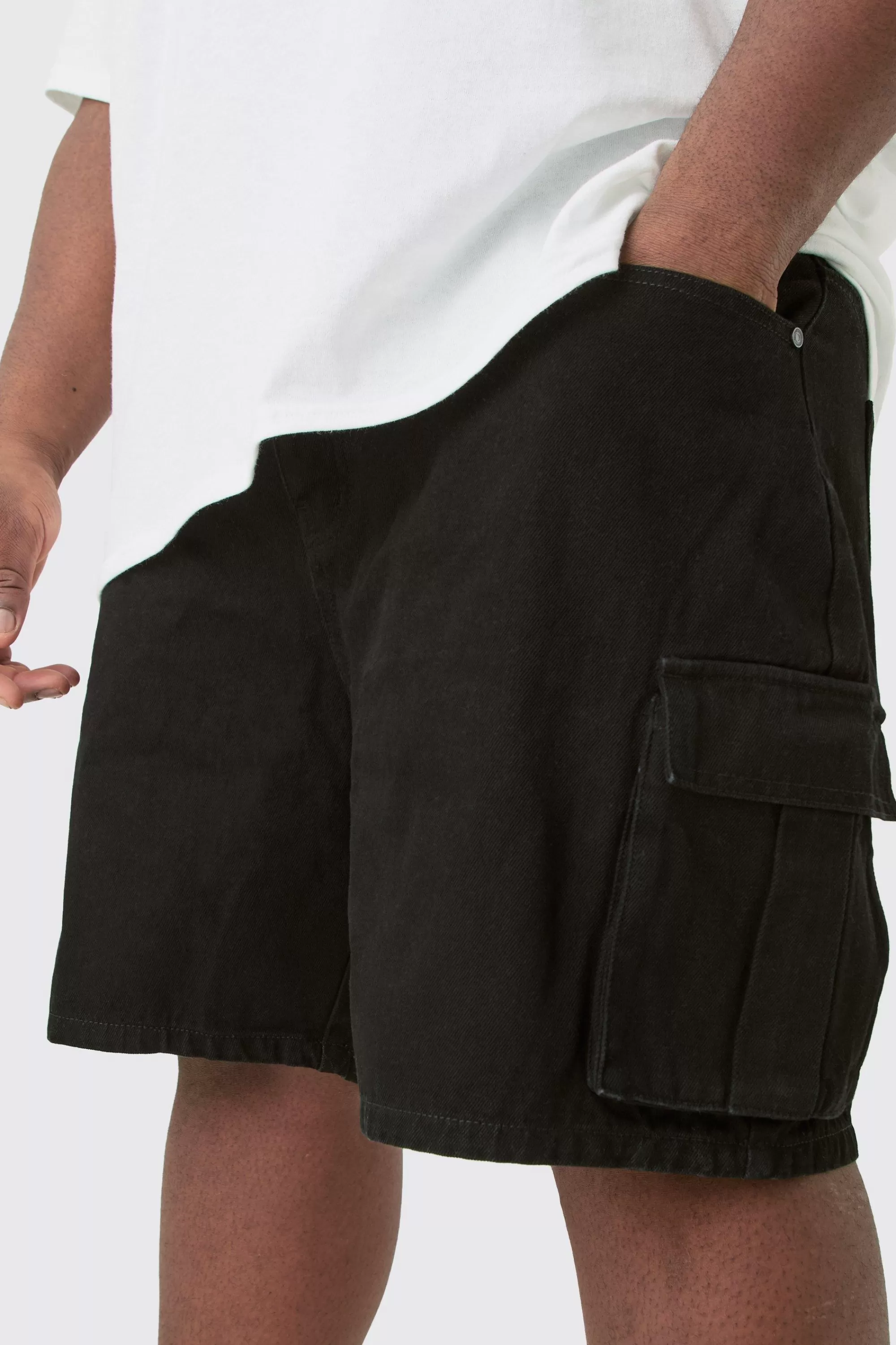 boohooMAN Plus Rigid Denim Relaxed Fit Cargo Shorts In Black | UK