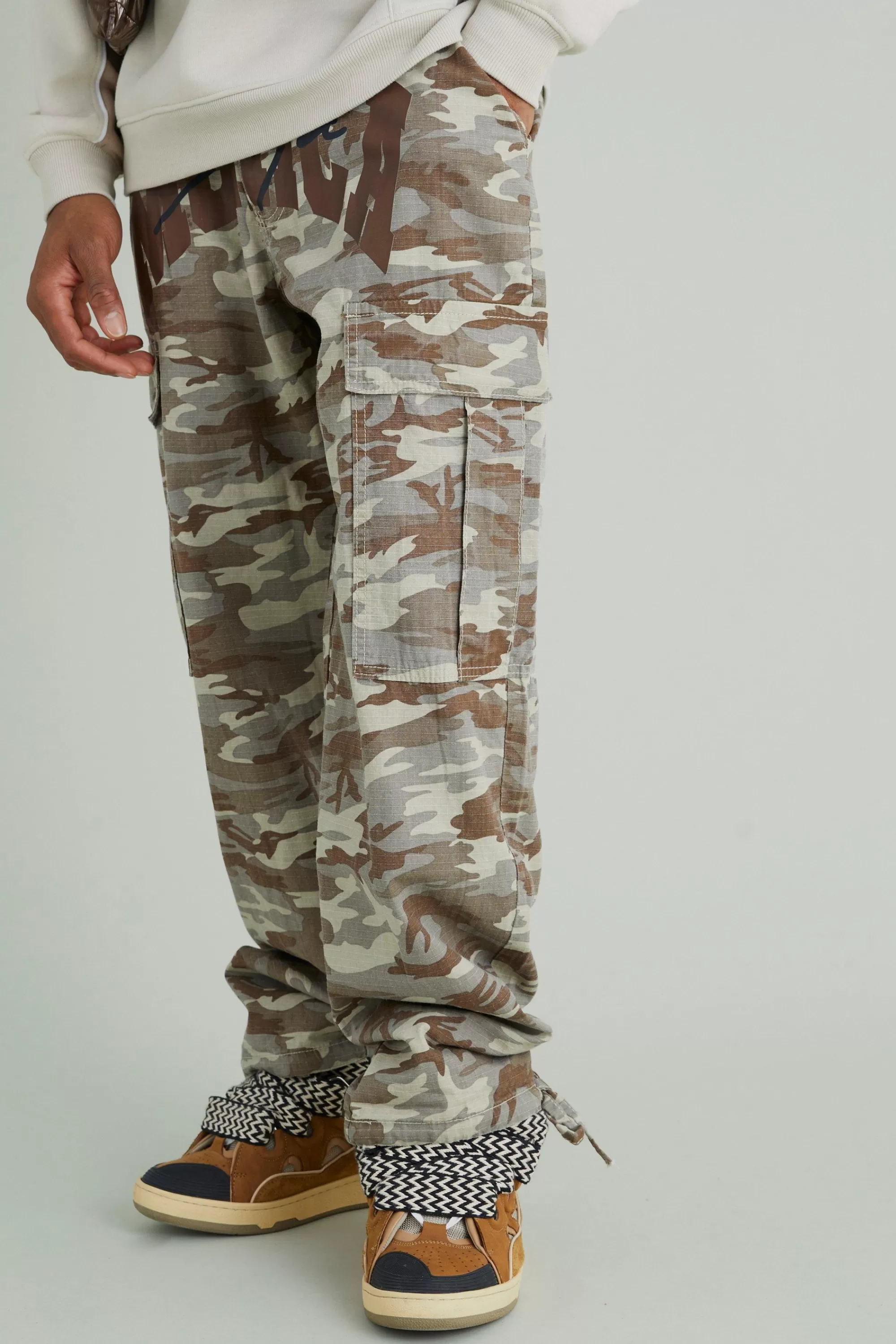 boohooMAN Relaxed Cargo Varsity Slogan Print Camo Trouser | UK