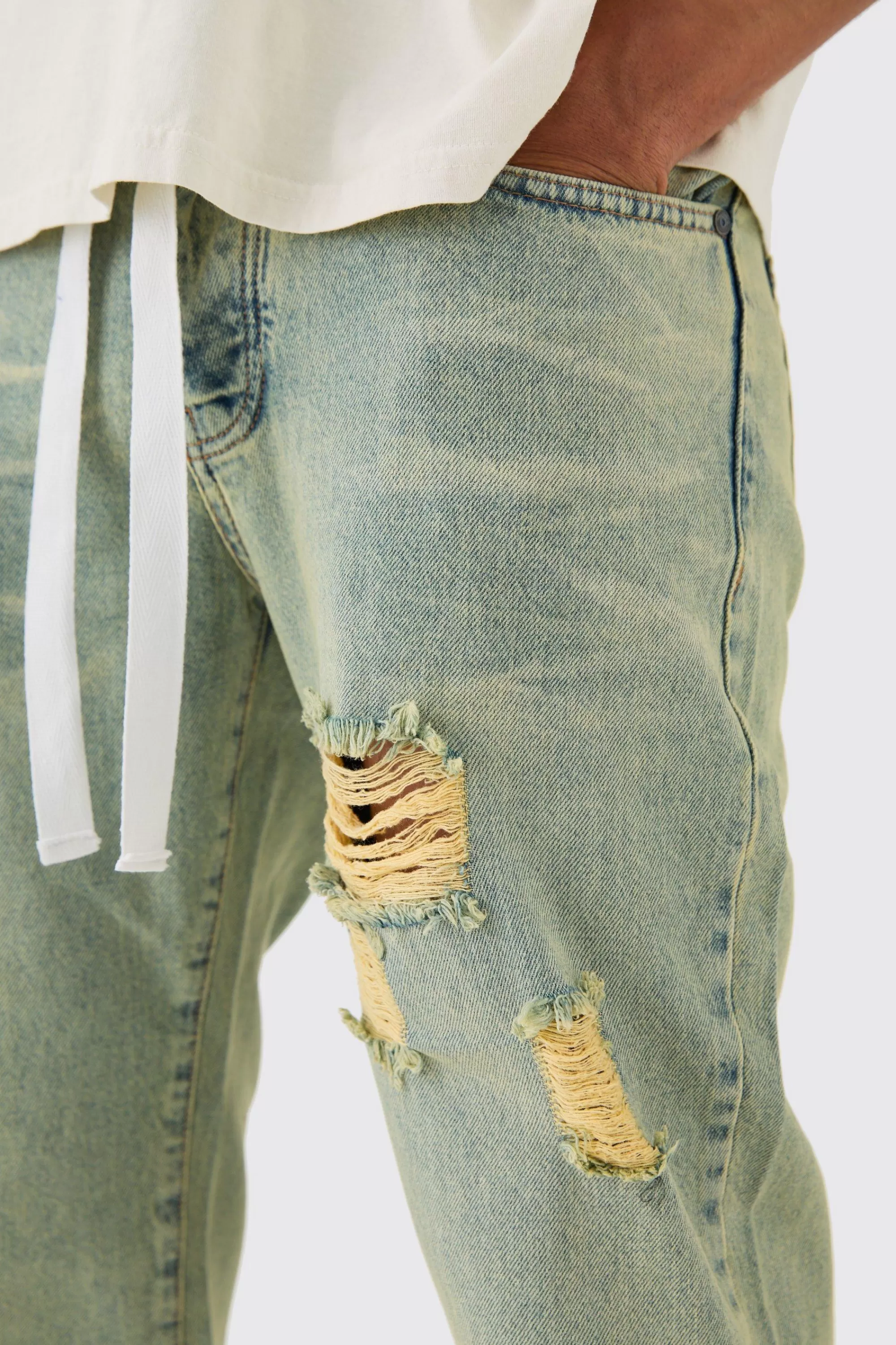 boohooMAN Relaxed Rigid Ripped Let Down Hem Jeans With Extended Drawcords In Wash | UK