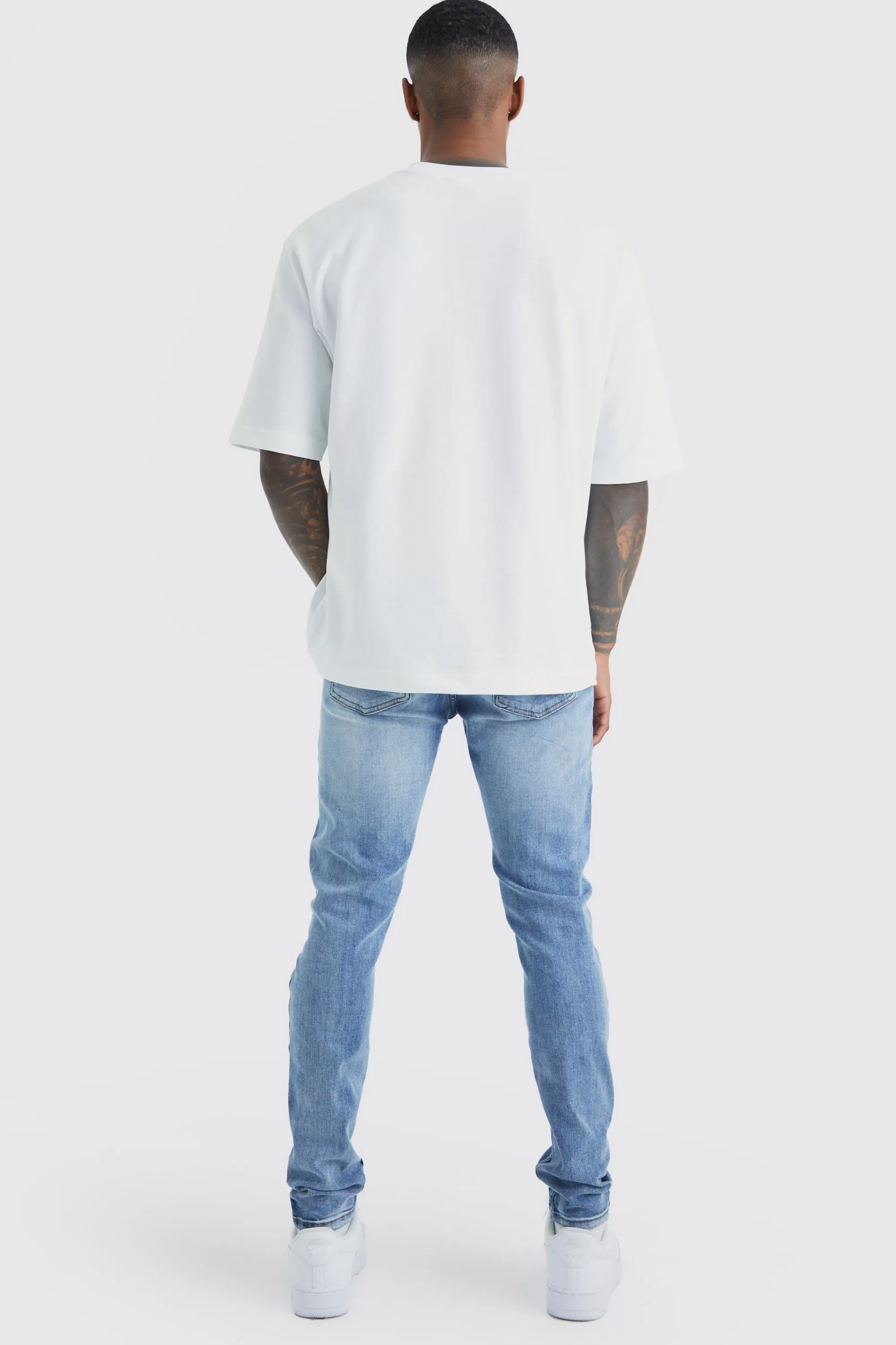boohooMAN Skinny Stretch Bleached Ripped Knee Jeans | UK