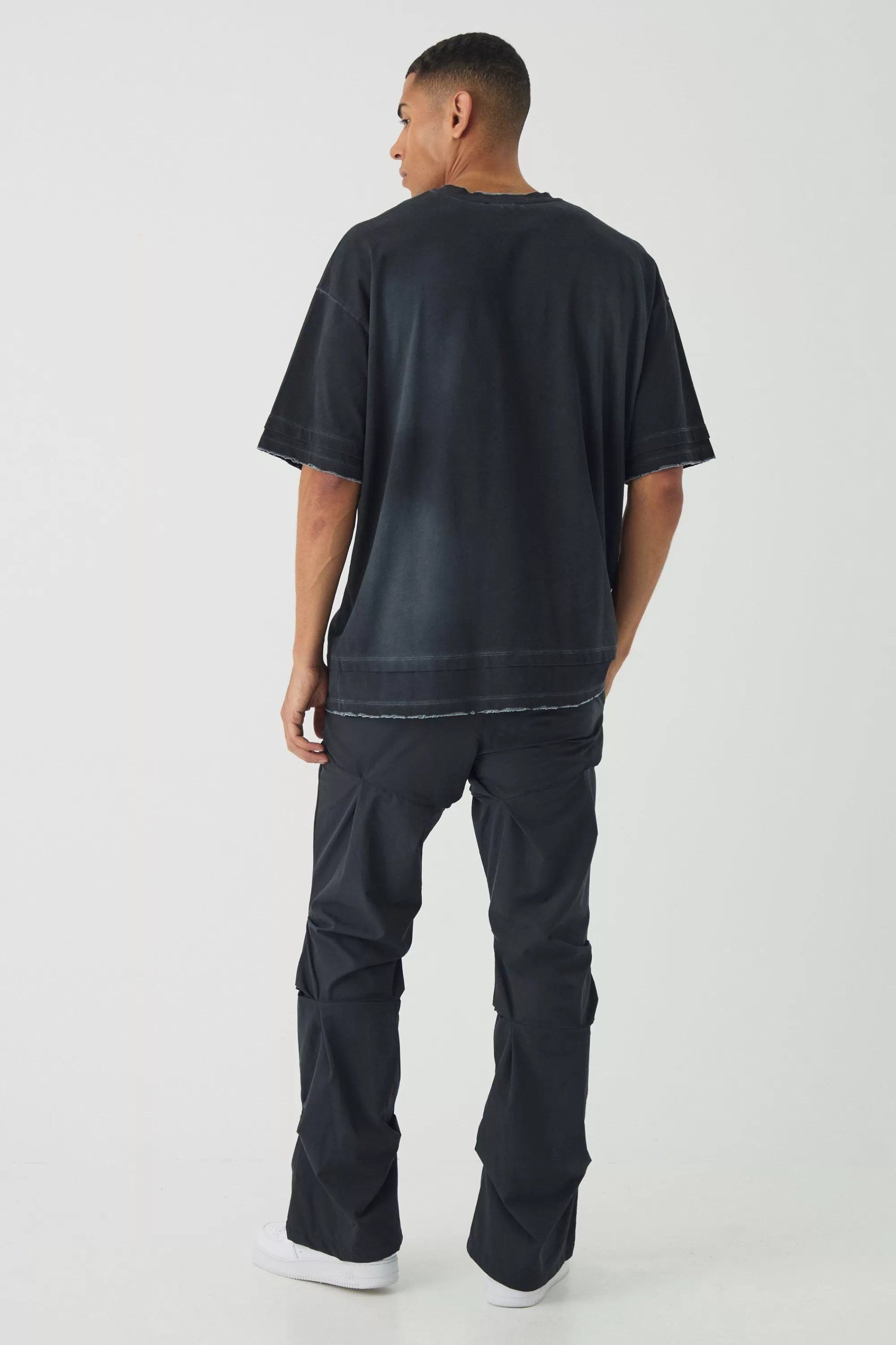 boohooMAN Slim Fit Flare Stacked Trousers With Ruched Detail | UK
