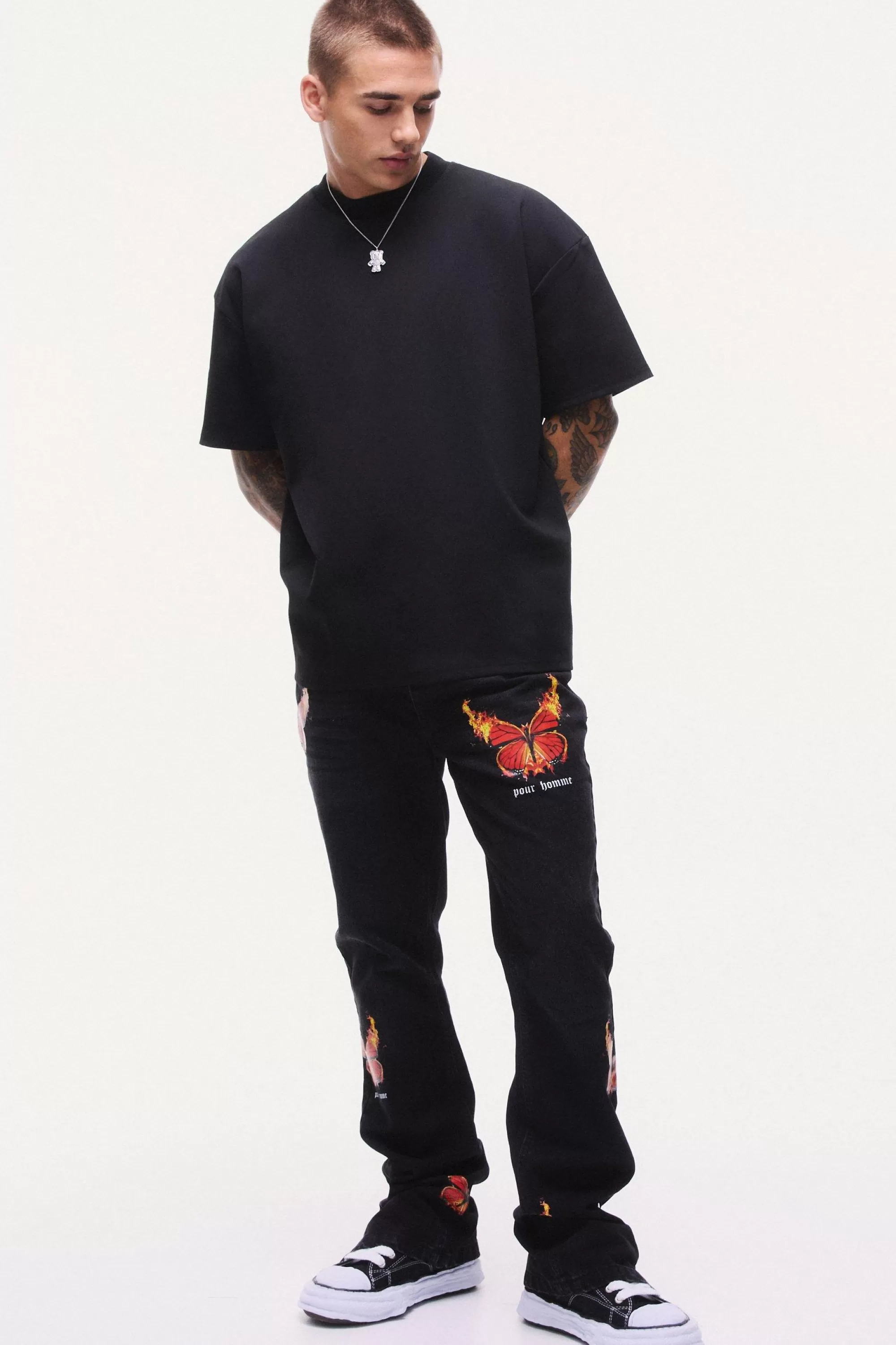 boohooMAN Slim Rigid Flare Popper Hem Graphic Butterfly Jeans | UK