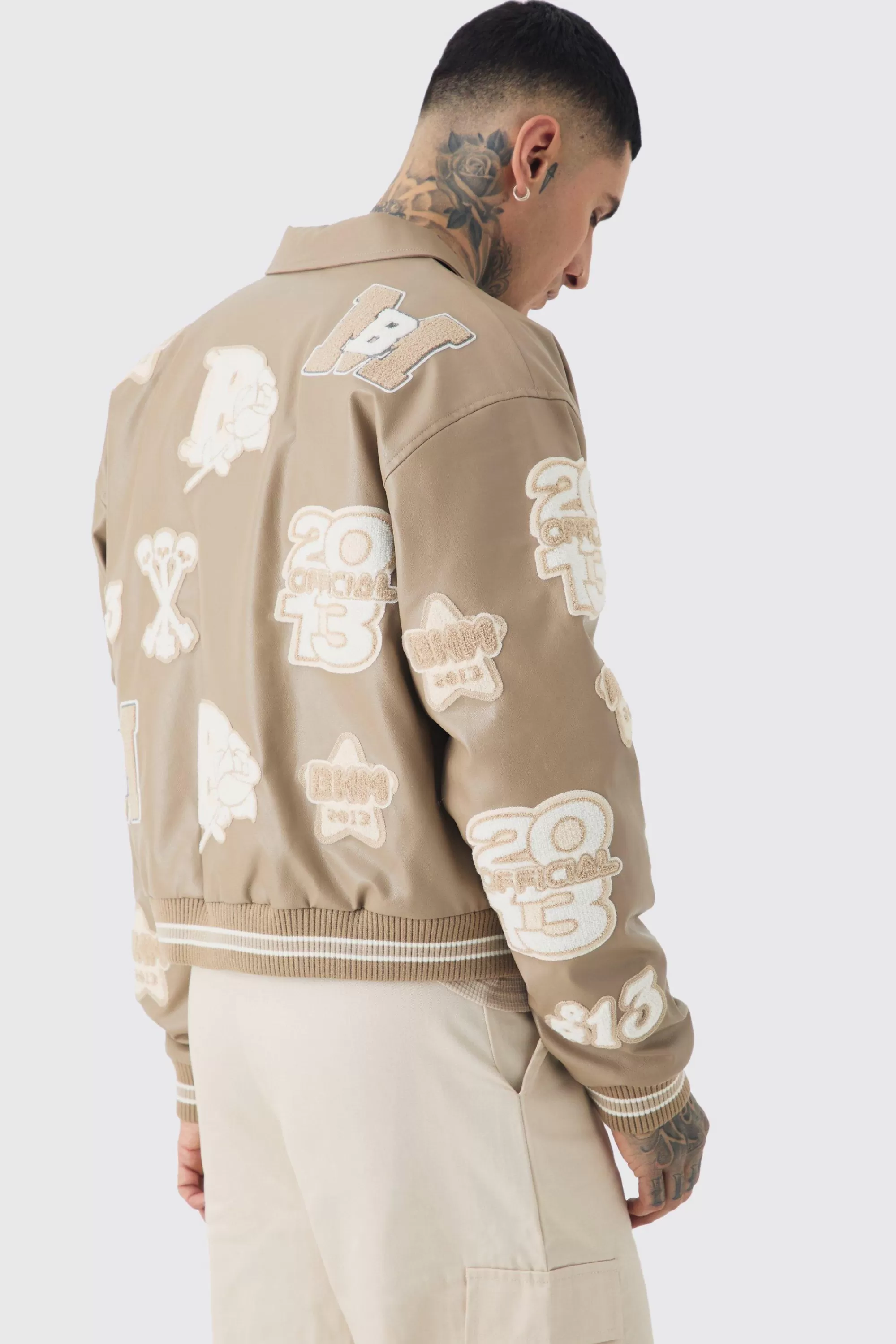 boohooMAN Tall Boxy PU Tonal Badge Varsity Jacket | UK