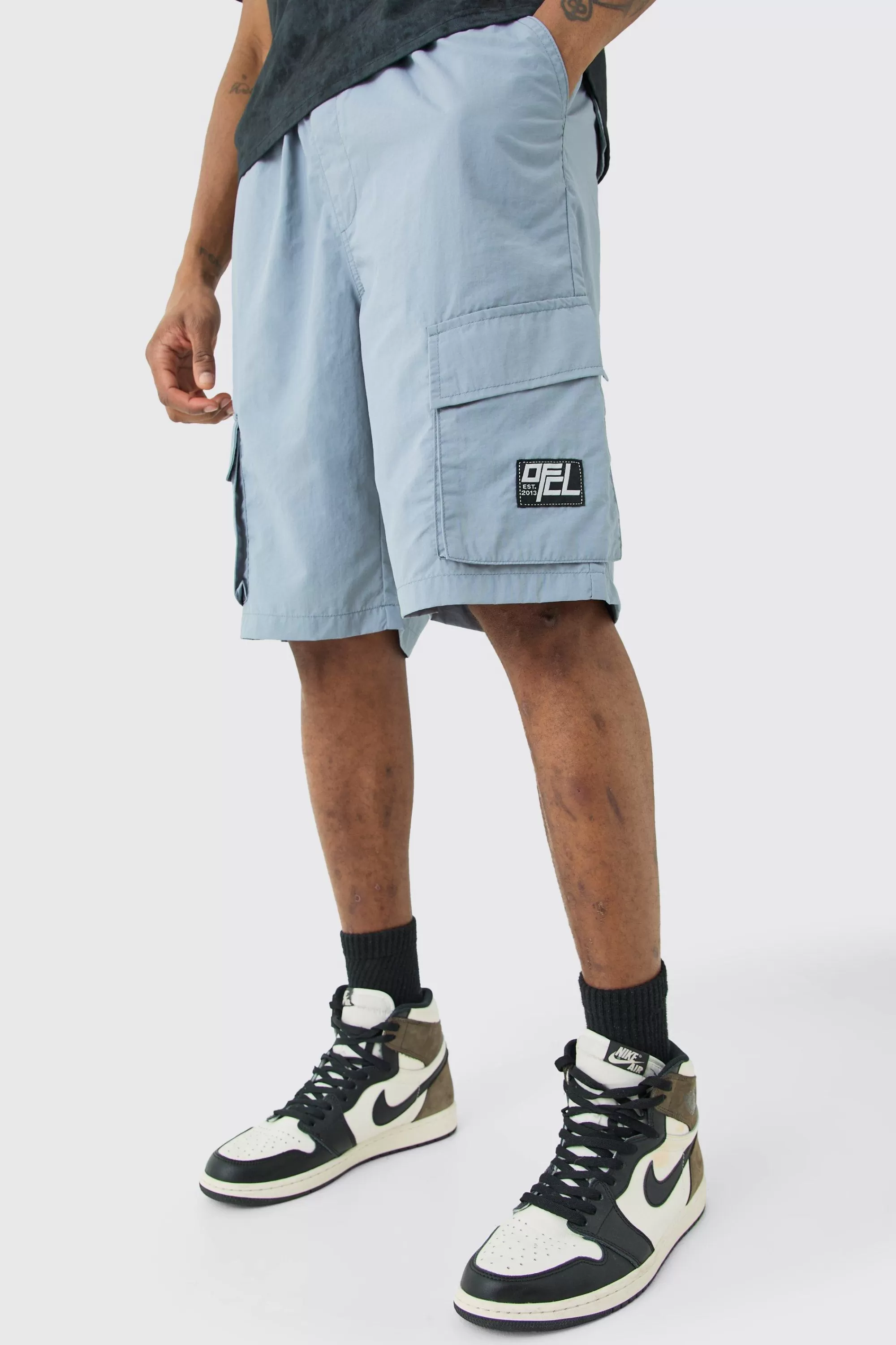 boohooMAN Tall Elasticated Waist Ofcl Nylon Cargo Short | UK