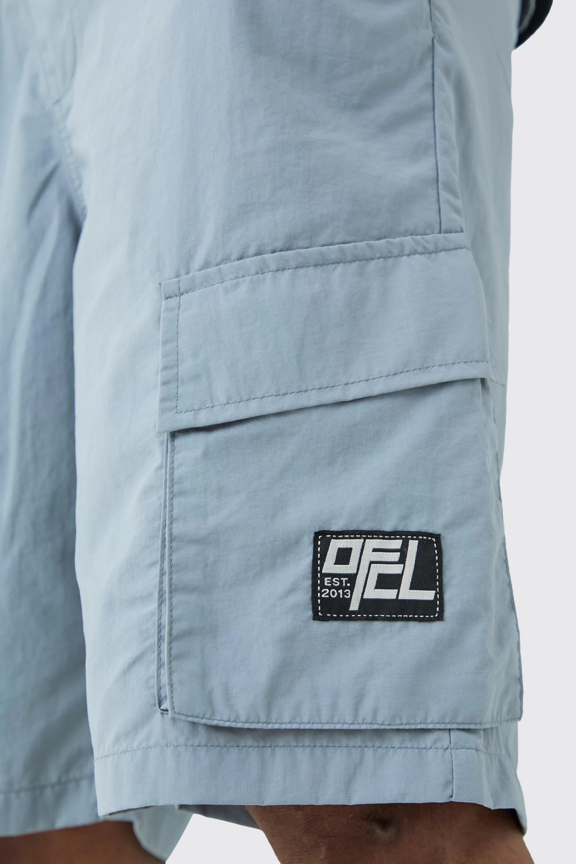 boohooMAN Tall Elasticated Waist Ofcl Nylon Cargo Short | UK