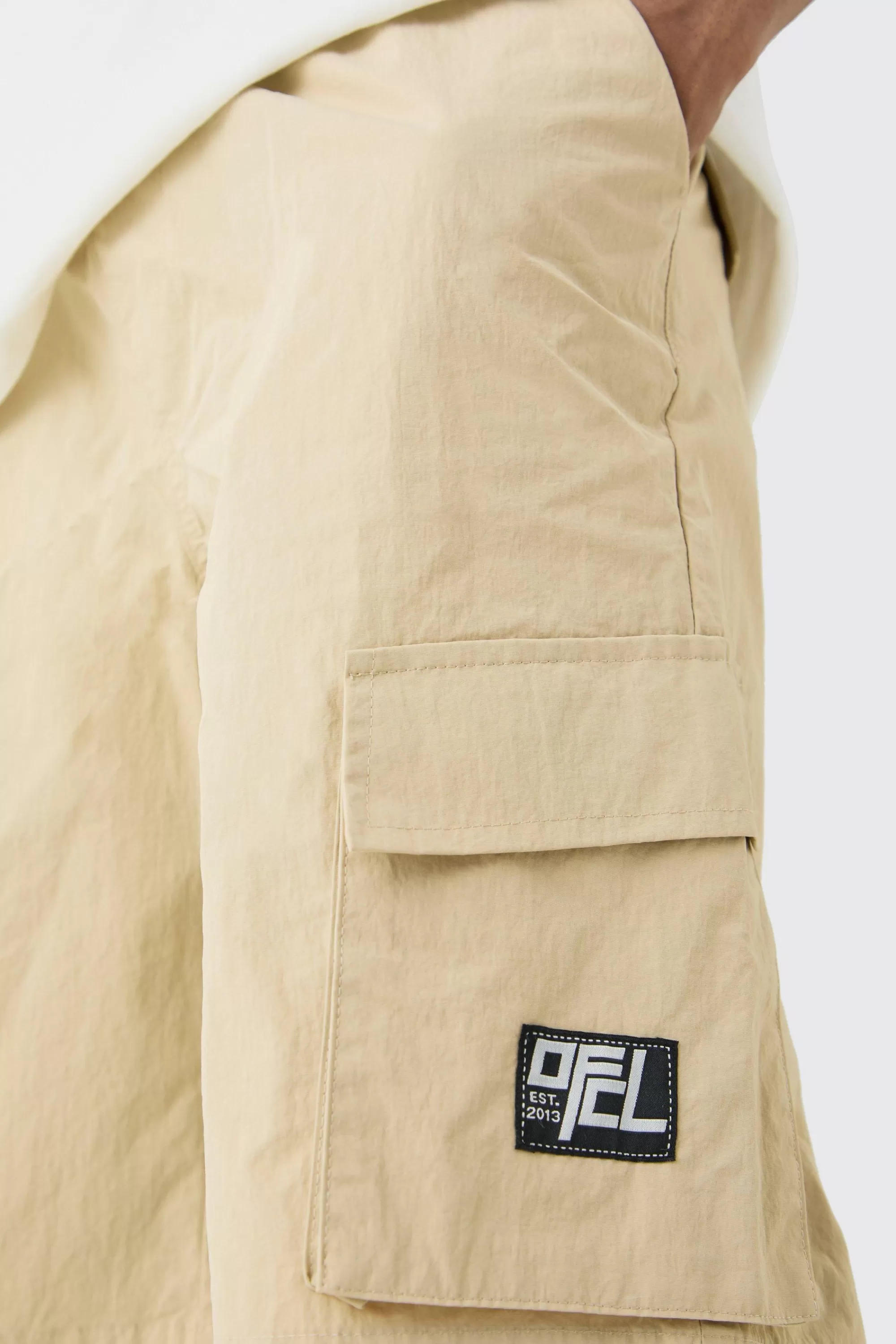 boohooMAN Tall Elasticated Waist Ofcl Nylon Cargo Short | UK